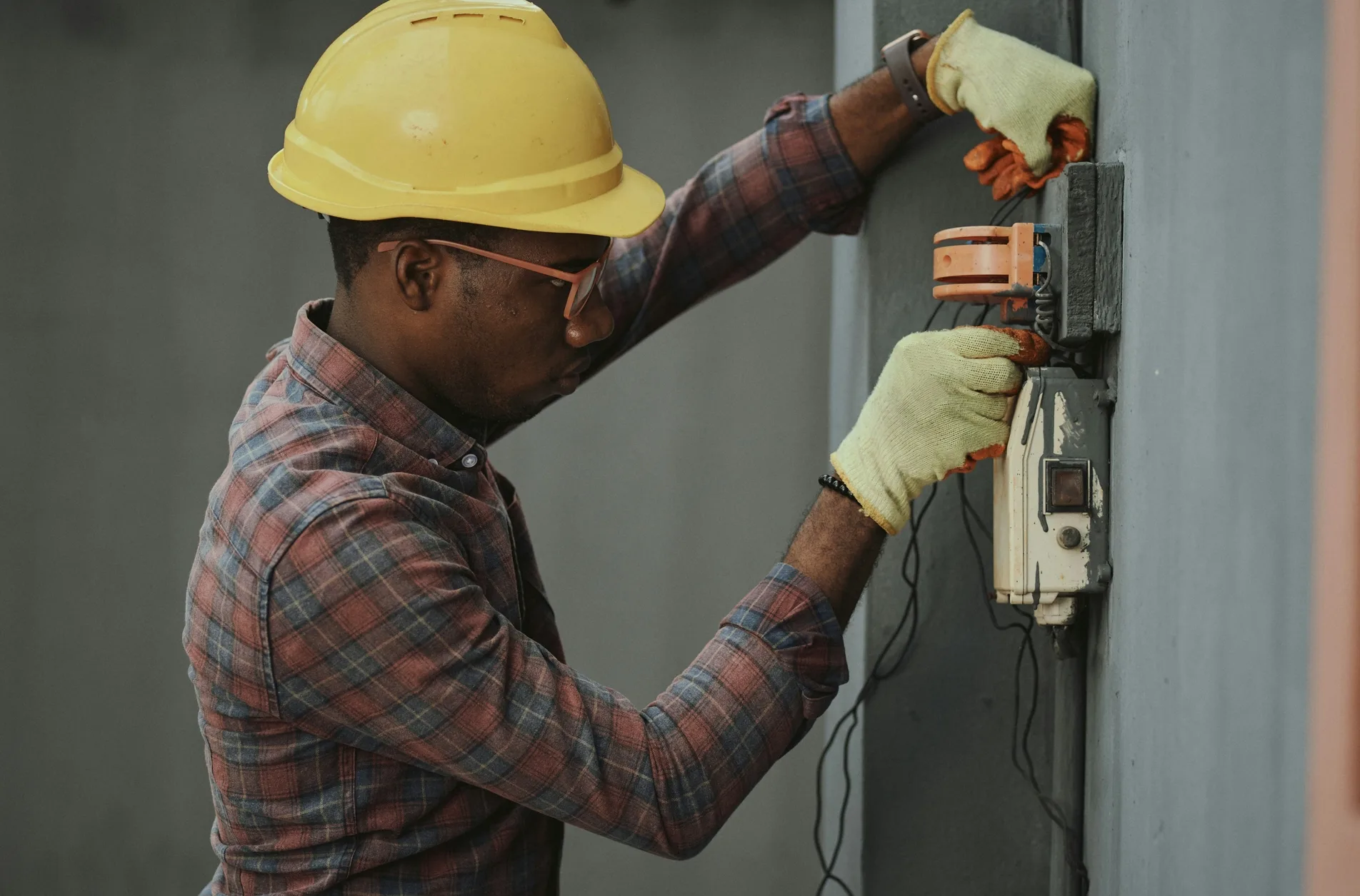 A worker is installing wall circuits A worker is installing wall circuits